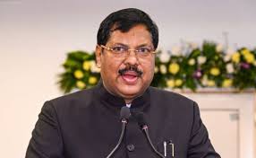 CJI Gavai speaking at a legal conference on judicial activism with constitutional symbols in the backdrop