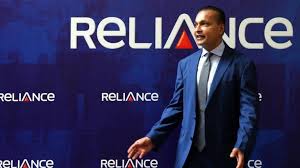 Anil Ambani with Reliance Power and Infrastructure logos showing company revival