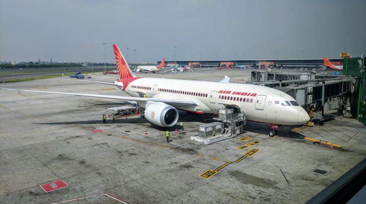 Air India Boeing 787 Dreamliner parked at airport terminal"
