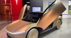 Tesla robotaxi prototype with autonomous navigation interface on city street