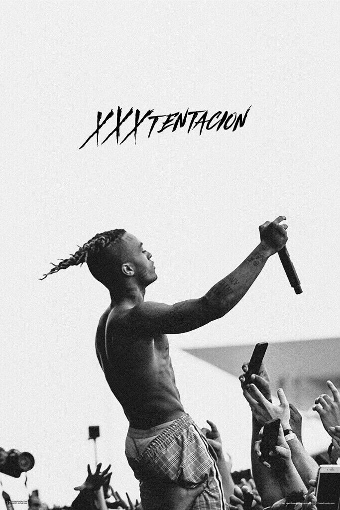 Portrait of XXXTentacion performing on stage during a concert, highlighting his energy and youth.
