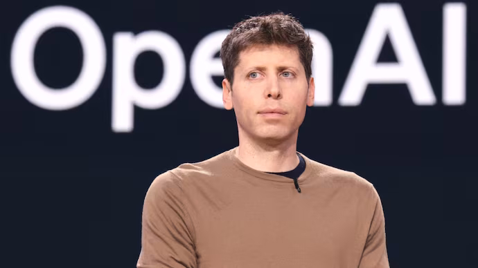 Sam Altman speaking at a tech event with OpenAI branding in the background, symbolizing leadership amid competitive industry dynamics.