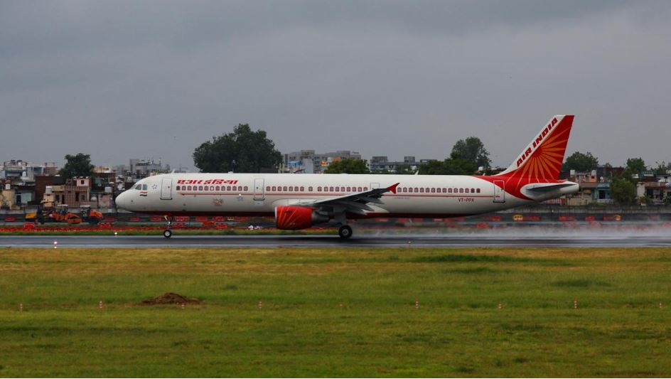 "Air India aircraft on tarmac amid announcement of 15% reduction in widebody international flights in 2025"