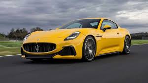 Stellantis and Maserati logos with a luxury car in background