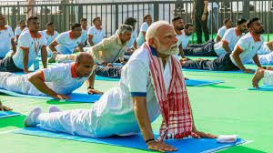PM Narendra Modi performing yoga with a crowd during International Yoga Day 2025 in Visakhapatnam