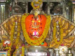 Entrance of Ganesh temple at Ranthambore with tourists and priest during celebration