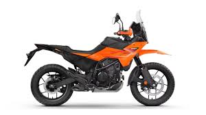 2025 KTM 390 Adventure X parked on rugged terrain with scenic background
