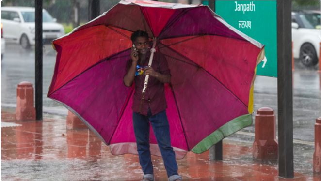 Heavy rain clouds over Delhi skyline with traffic and city landscape