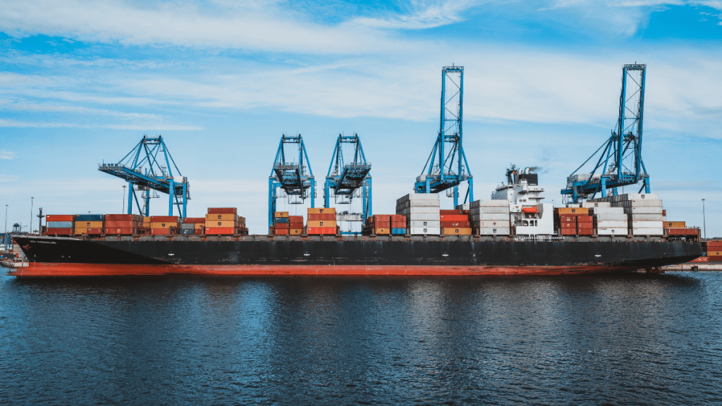 Cargo ships near Strait of Hormuz with map overlay showing alternative trade routes