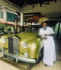 Karunas Tamil actor standing next to his Rolls Royce luxury car