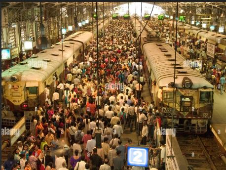 Crowd walking along Mumbai railway tracks with blurred train in background, symbolizing the silent human toll of unclaimed deaths