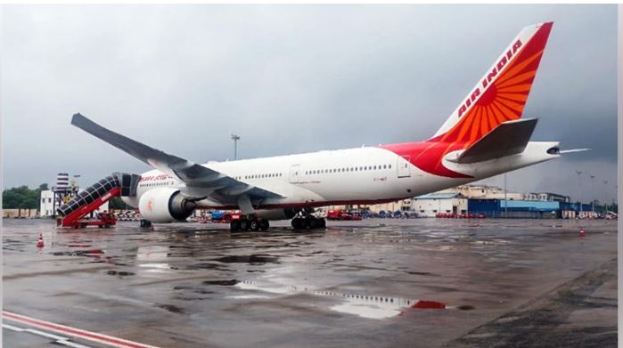 Air India aircraft grounded at tarmac with global map in background highlighting flight suspensions to West Asia and North America