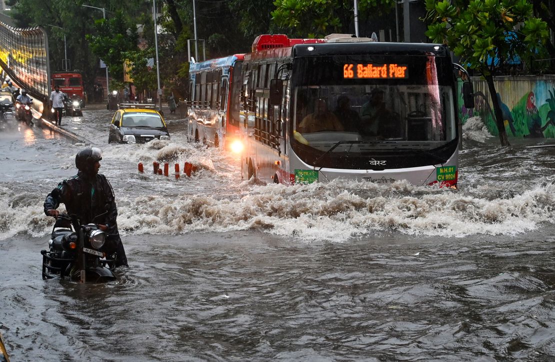Flooded Indian street during Monsoon 2025 with vehicles submerged and people wading through water