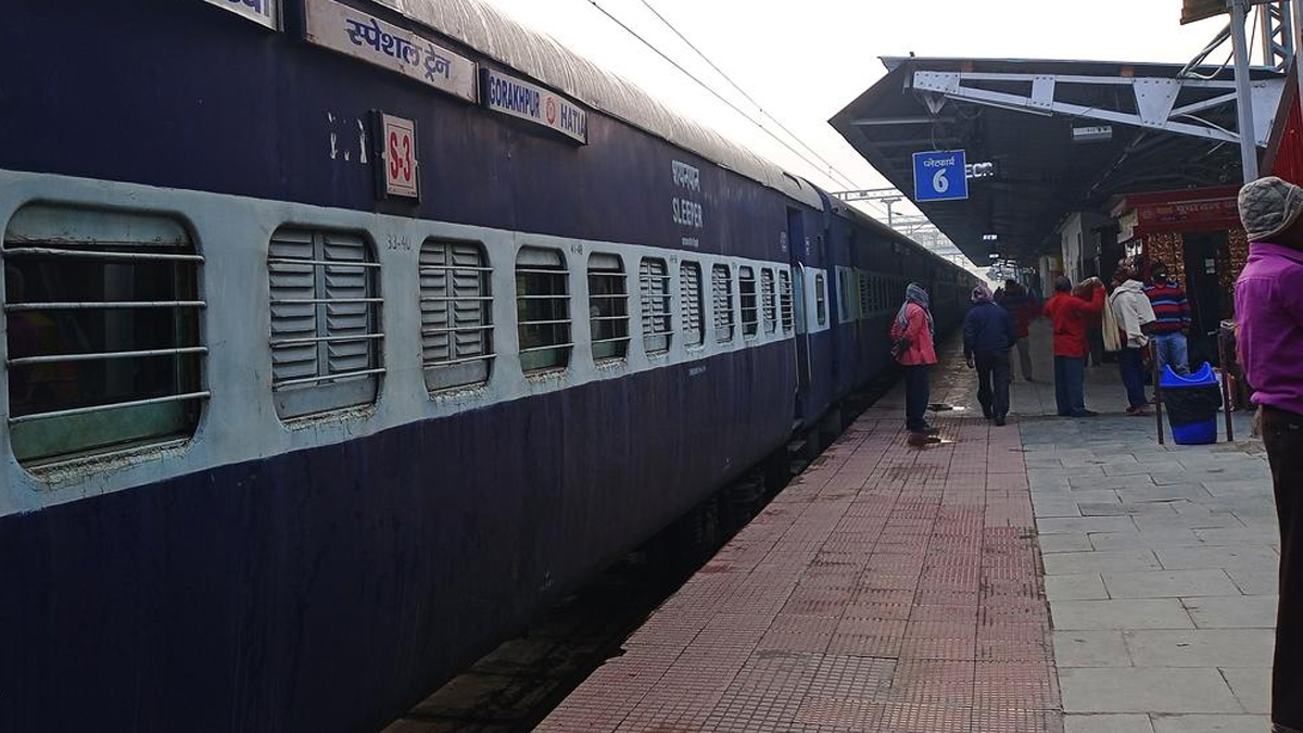 Indian train at a platform with passengers boarding, fare hike update banner