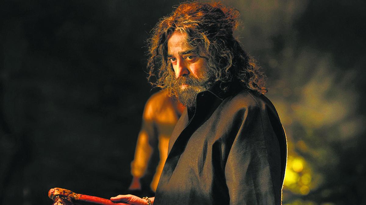 Kamal Haasan in a scene from Thug Life, surrounded by OTT platform visuals and legal symbols