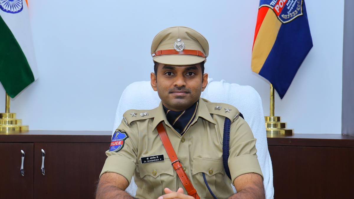 Police officers checking helmets during crackdown on helmetless riders in Mulugu