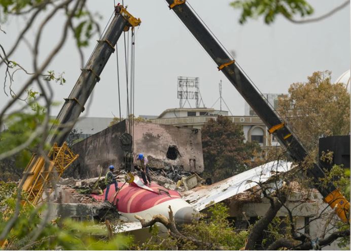 Wreckage being removed at Ahmedabad plane crash site during recovery operation