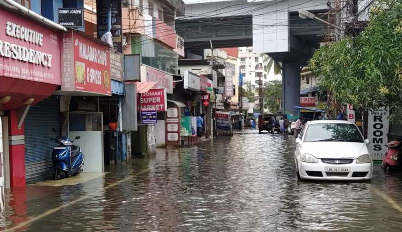 “Flooded street outside a closed school in Karnataka during heavy monsoon rain in June 2025”