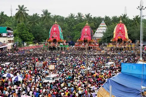 Devotees pull Lord Jagannath’s chariot during the 148th Rath Yatra in Ahmedabad.