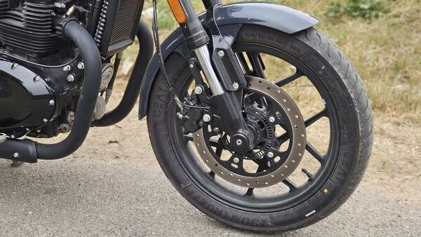 Motorcycle equipped with Anti-Lock Braking System (ABS) parked on urban road, representing new safety mandate from 2026 in India