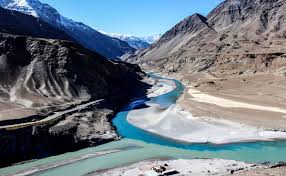 Indus River at dawn with hydroelectric plant infrastructure in the background