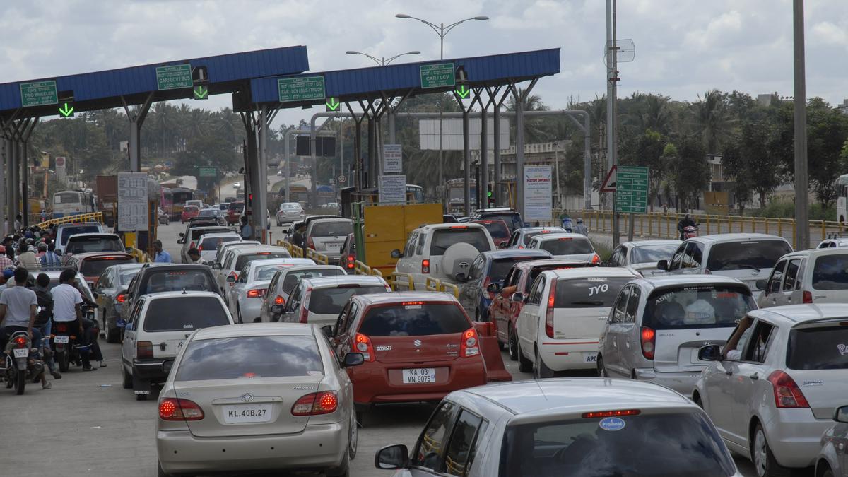 Traffic passing through toll booths on Bengaluru’s Electronics City flyover after toll rate hike.