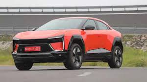 Mahindra BE.06 electric SUV driving along India's coastal edge