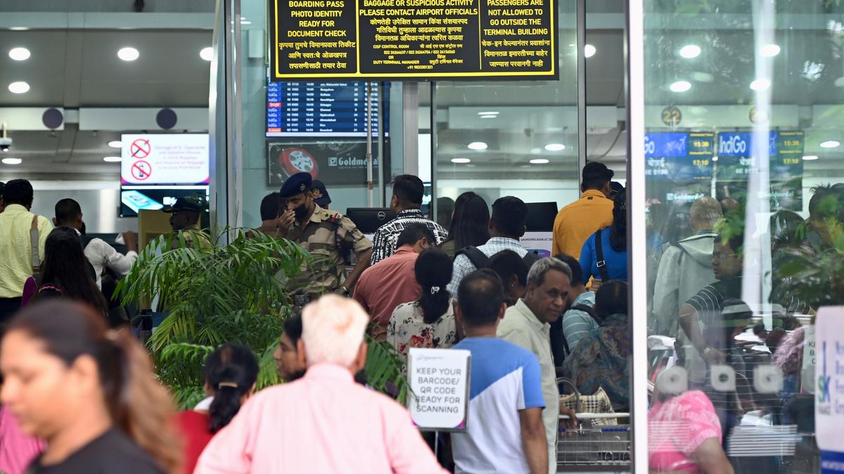 Mumbai airport security personnel confiscating live snakes during passenger arrest