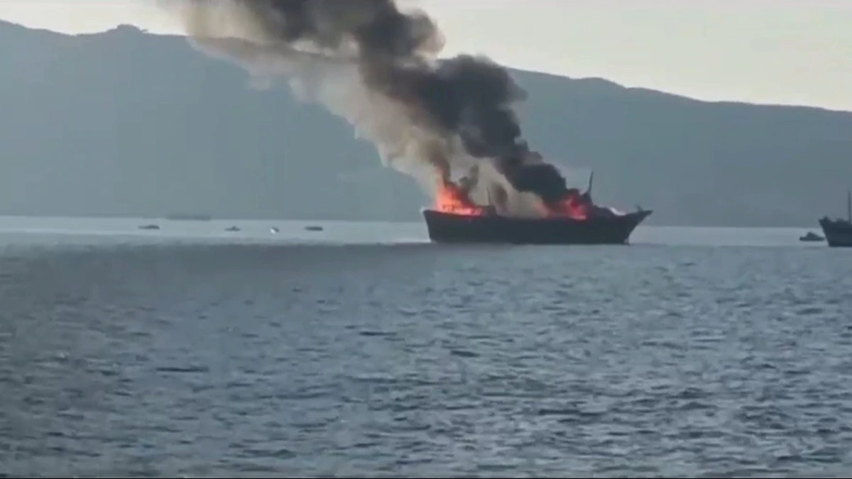 INS Sunayna approaching an Oman-bound vessel on fire in the Arabian Sea.