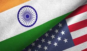 India-US flags with genetically modified corn and soybean fields in background, representing trade dispute
