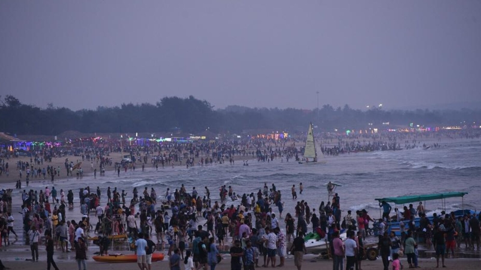 Crowded Goa beach during peak tourist season in July 2025