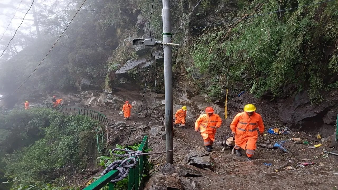 Rescue personnel inspecting landslide debris on the Yamunotri highway after heavy monsoon rains