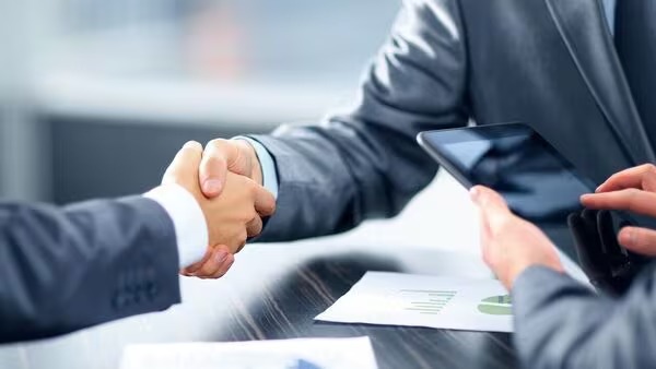 A person reviewing a pre-approved loan offer on their smartphone with checklist and interest rates shown.