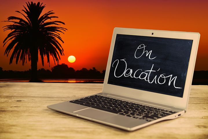 Young couple planning a vacation using Vizzve Finance travel loan on a laptop.