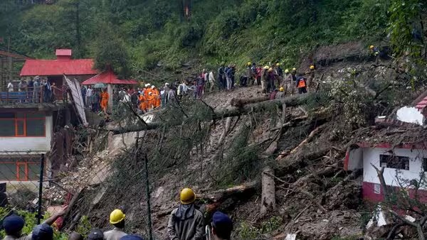 Landslide aftermath in Himachal Pradesh with debris covering roads and rescue teams working in Mandi district