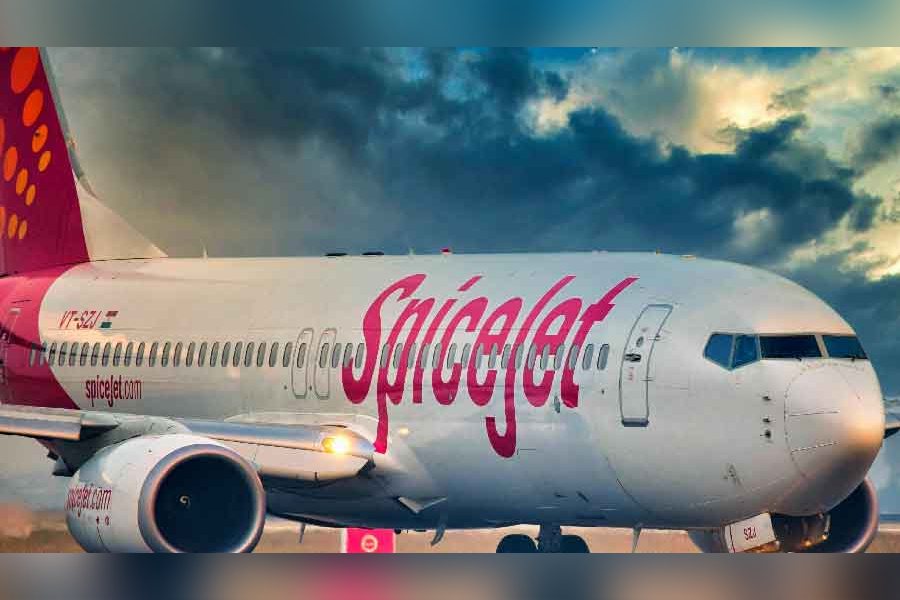 SpiceJet aircraft window mid-air with cabin crew checking damage after window frame dislodges