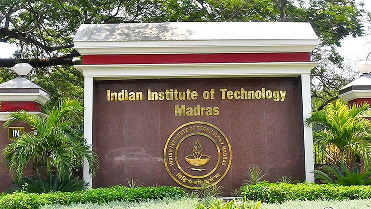 Students learning online with IIT Madras logo behind a laptop