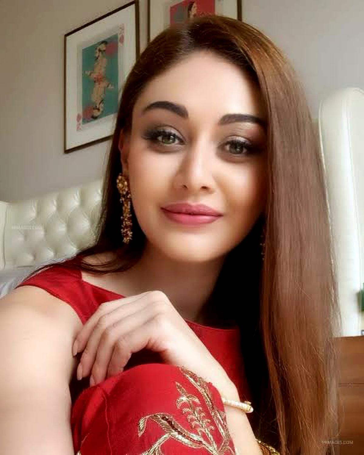 Close-up of medicine bottles and a blood pressure monitor on a table"
