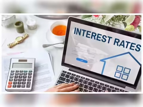 Employee reviewing loan interest rate options on laptop