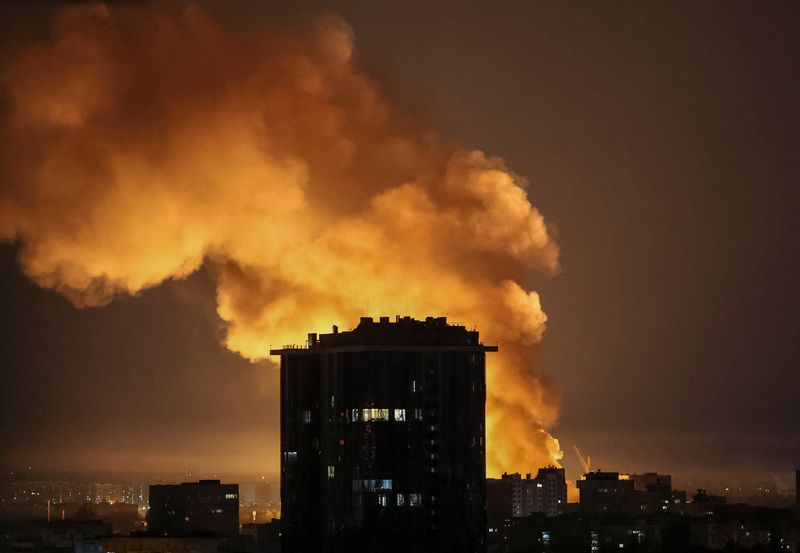 Smoke and fire rise from a residential building in Kyiv after a missile strike during Russia's aerial assault.