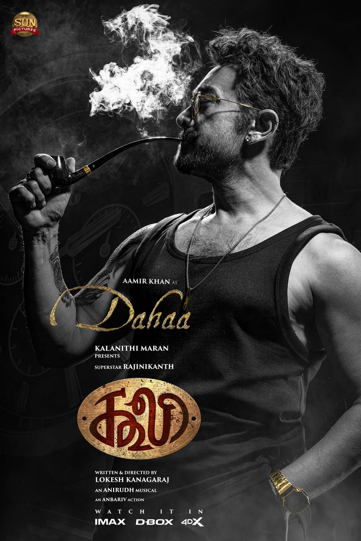 Aamir Khan in his first look from ‘Coolie’ with an intense expression, set against a gritty industrial backdrop.