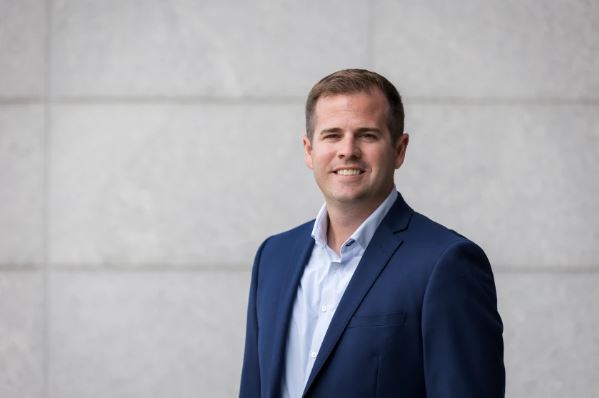 "Marshall Grams speaking about values-driven finance at a leadership summit"