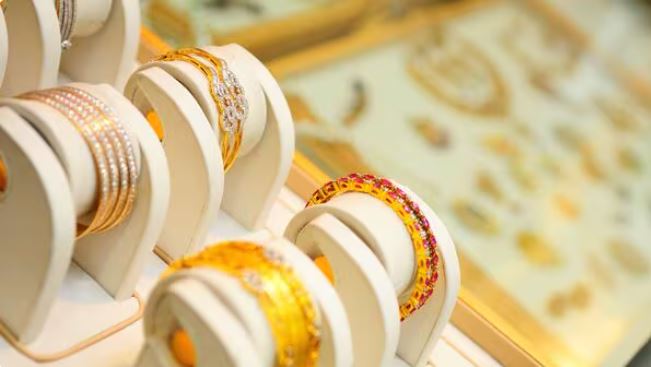 "MCX gold price graph showing decline near ₹96,500 with gold bars and Indian rupee notes"