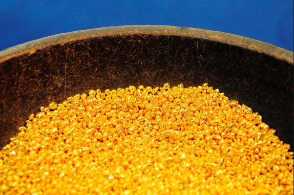 "Gold bars with a declining graph in the background reflecting market reaction to tariff news"