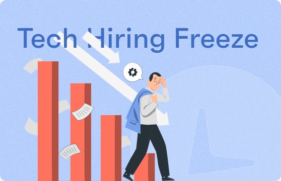 Young tech professional looking stressed at laptop, with a hiring freeze headline on screen and Vizzve app open