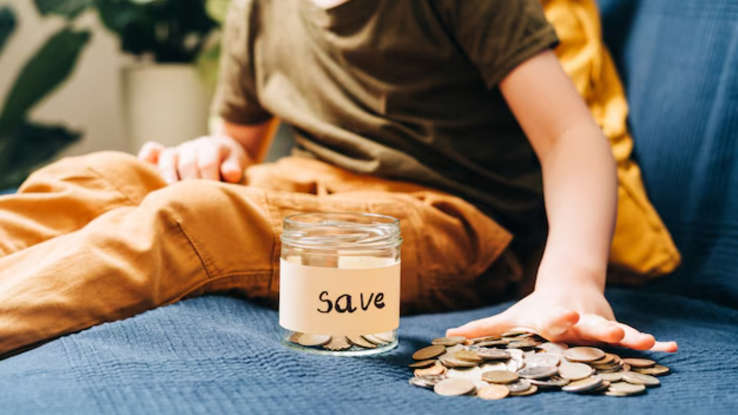 Happy young Indian woman saving money while sipping coffee, stress-free