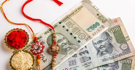 Brother and sister holding a piggy bank with rakhi on wrist, symbolizing shared financial goals