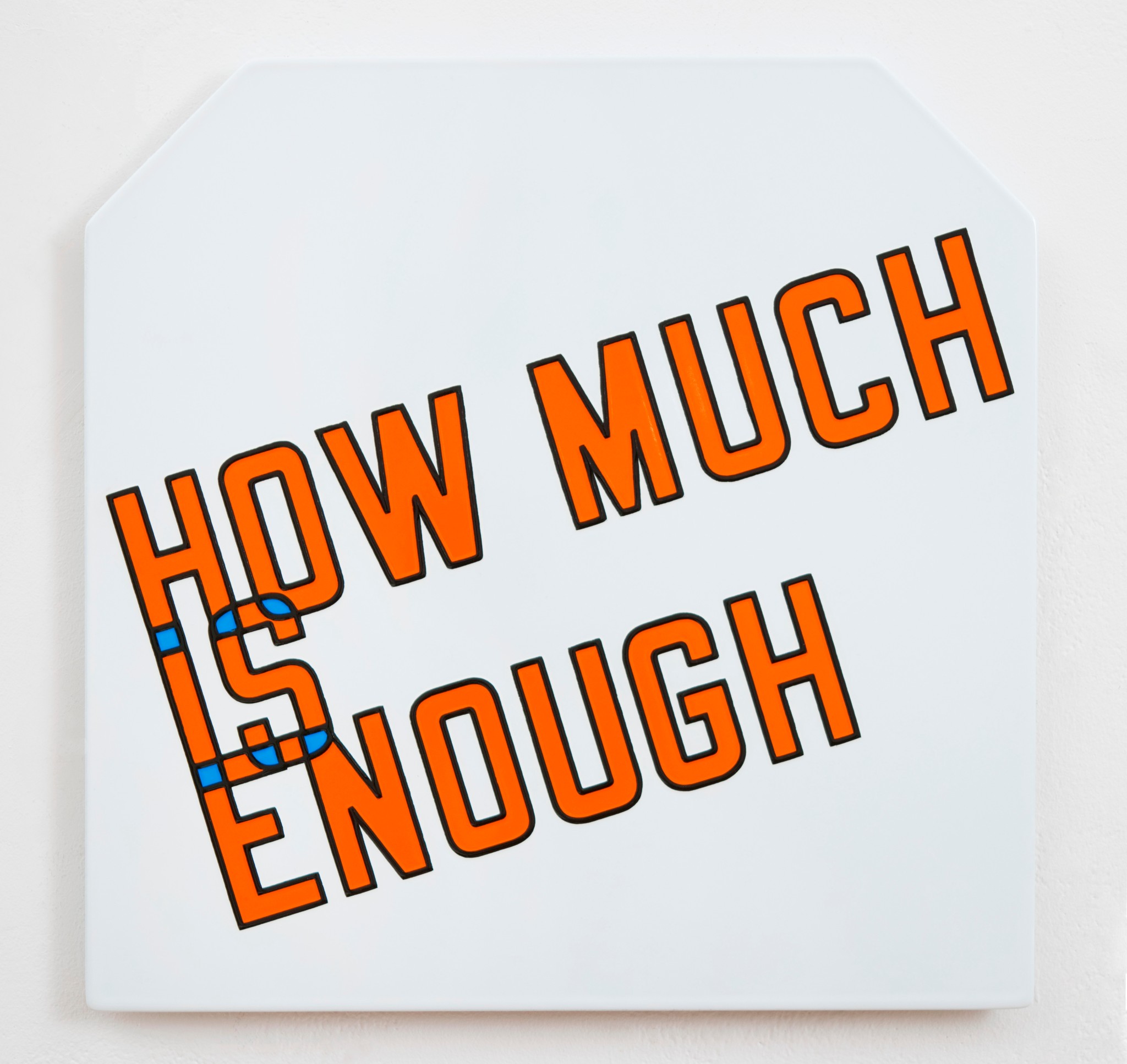 Notebook with the question “How much is enough?” written on it, next to a calculator and rupee coins on a desk