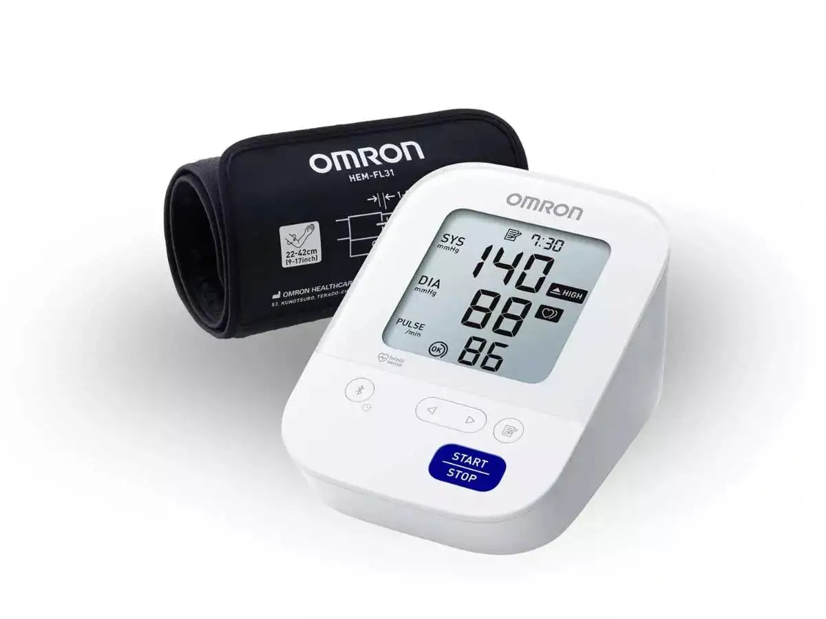  Indian family using Omron smart blood pressure monitor at home with health app open – Vizzve Finance