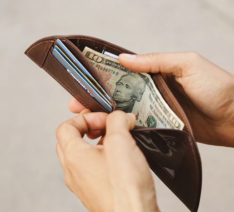  A person standing tall with a heart and rupee symbol balanced, representing self-worth beyond money